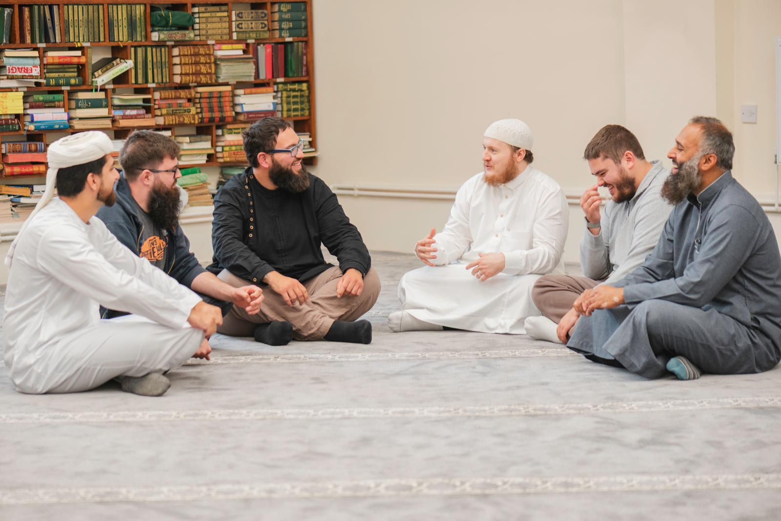 A circle of brothers talking together at a monthly social
