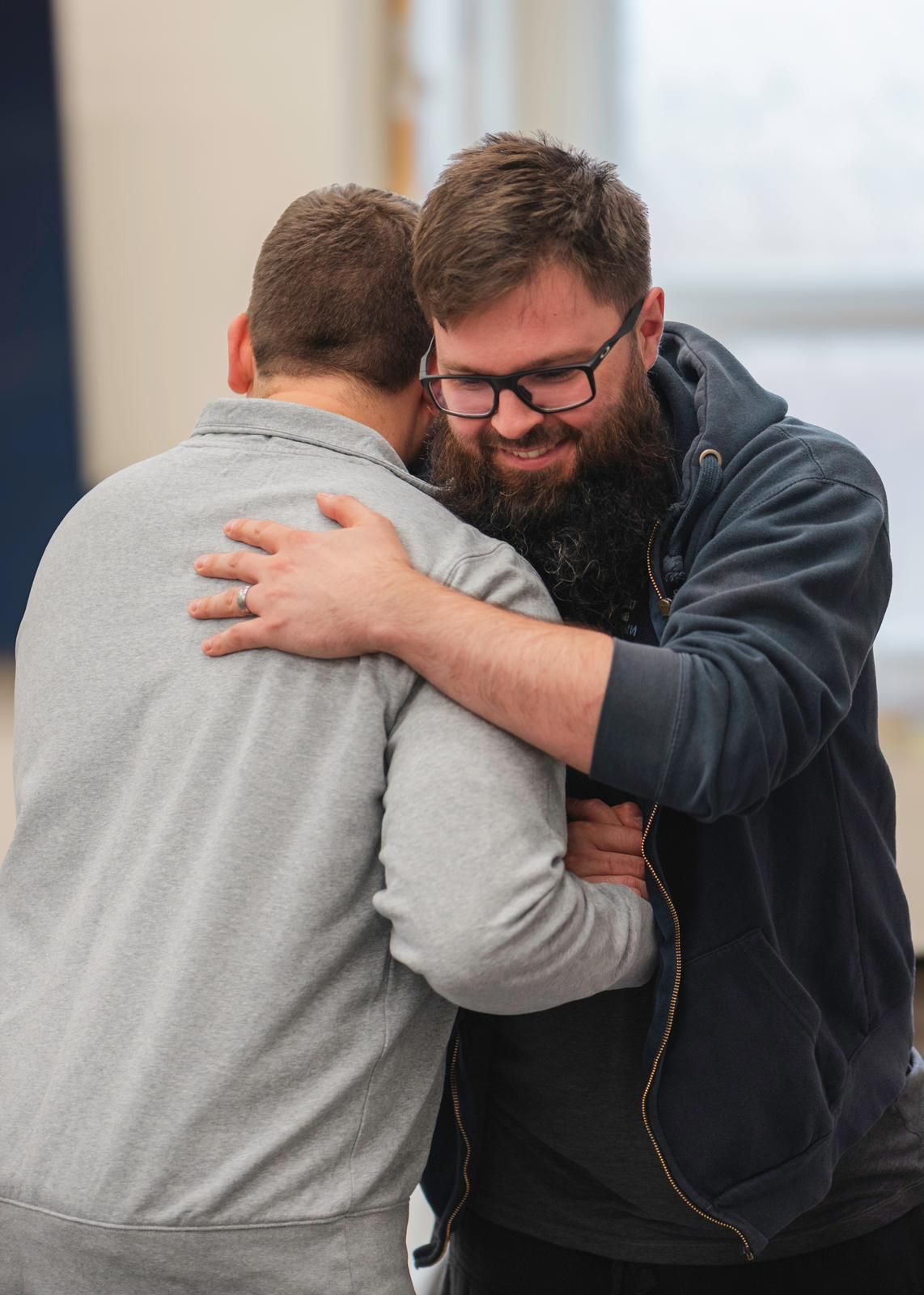 Two friends embracing at a Bristol Revert Network gathering